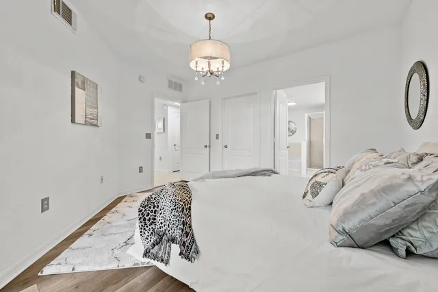 a bedroom with a bed and a chandelier