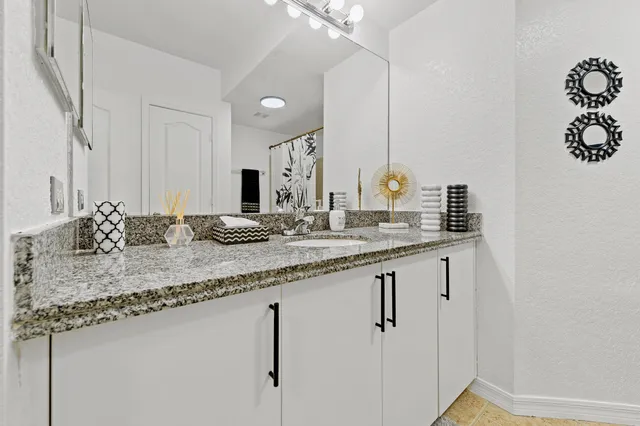 a bathroom with a sink and a mirror