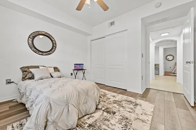 a bedroom with a bed and a chandelier