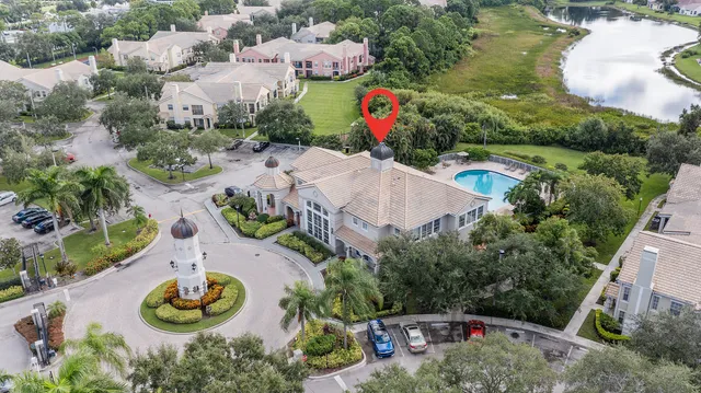 an aerial view of a house with swimming pool and lake view