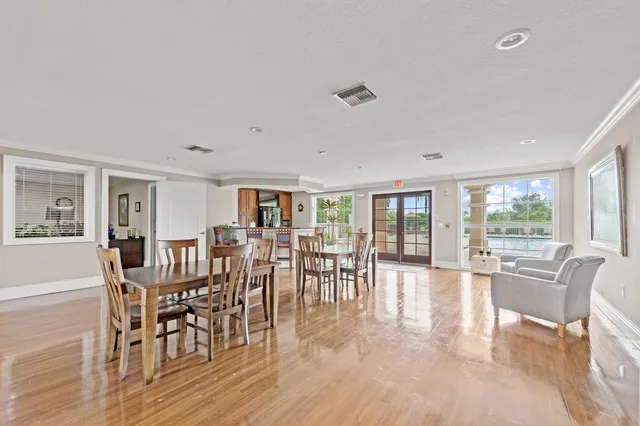 a view of a dining room with furniture wooden floor and chandelier