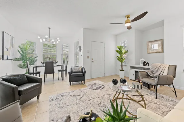 a living room with furniture and a chandelier