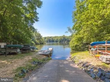 a backyard of a house with fire pit and outdoor seating
