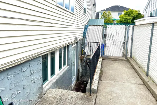 a backyard of a house with outdoor seating