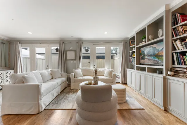 a living room with furniture and a book shelf