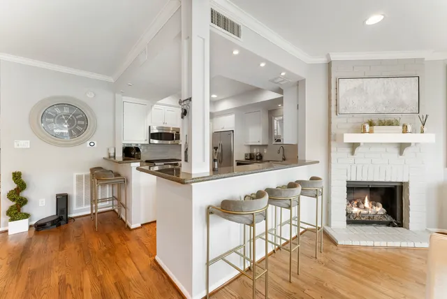 a kitchen with a table chairs refrigerator and cabinets
