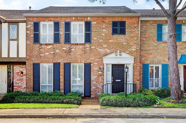 a front view of a house with a yard and plants