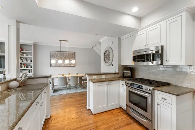 a kitchen with stainless steel appliances granite countertop a stove and a sink