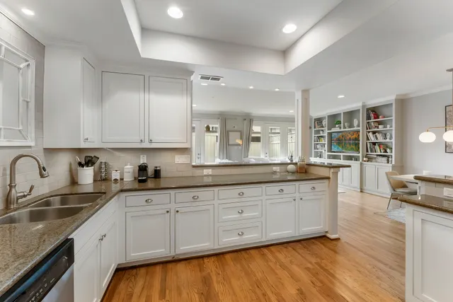 a kitchen with granite countertop white cabinets and white appliances