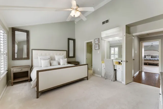 a bed room with a bed and a chandelier