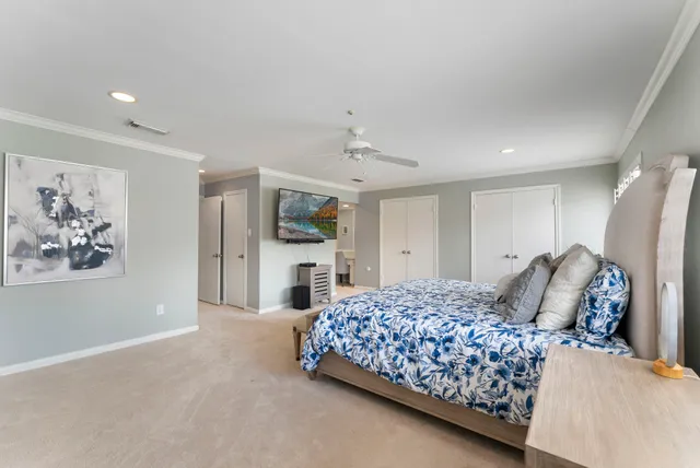 a bedroom with a large bed and a chandelier