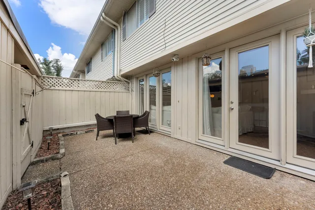 a view of a patio with table and chairs