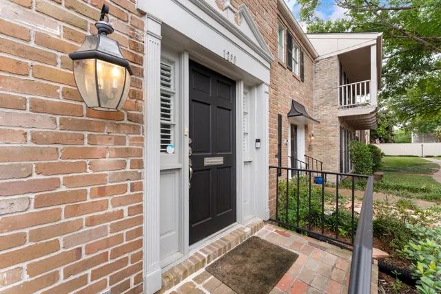 a view of a brick house with a large window