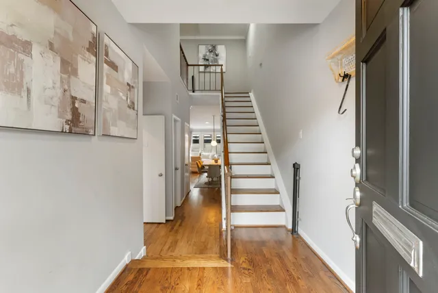 a view of entryway and hall with wooden floor