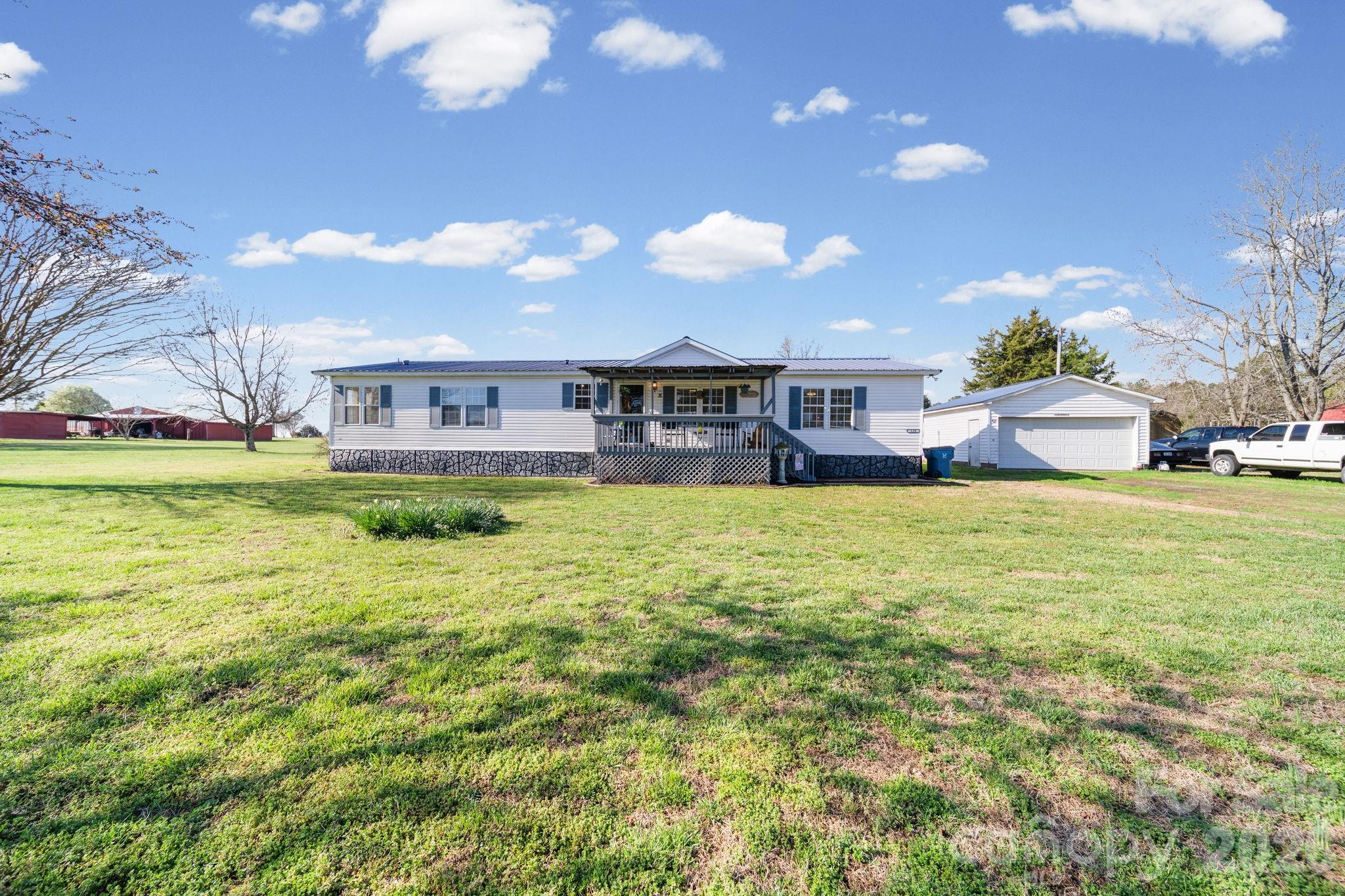 139 Old Fallston Road Cherryville, NC 28021 - Photo 2 of 47 a view of a house with a big yard and potted plants