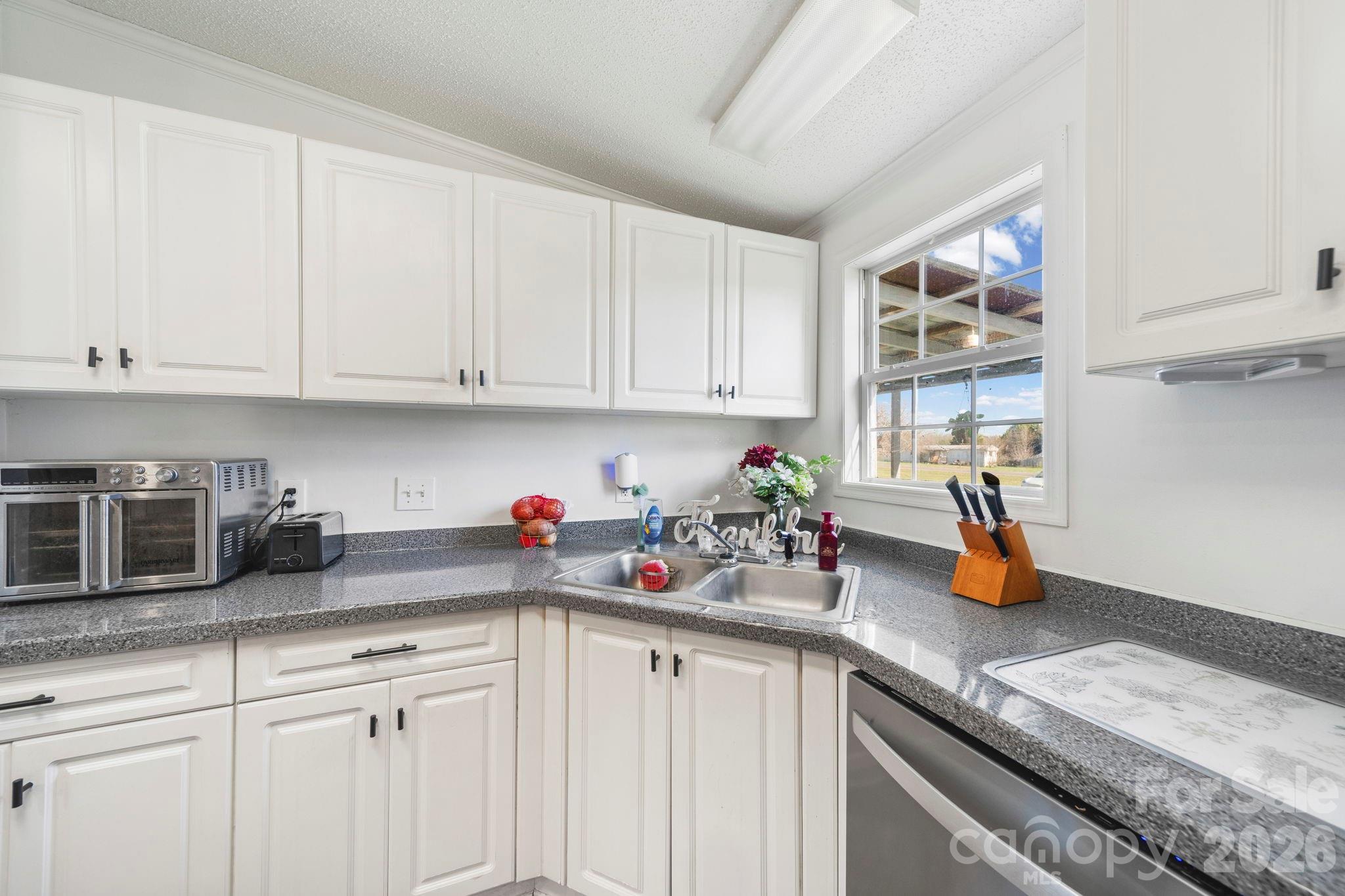 139 Old Fallston Road Cherryville, NC 28021 - Photo 24 of 47 a kitchen with a sink dishwasher and cabinets