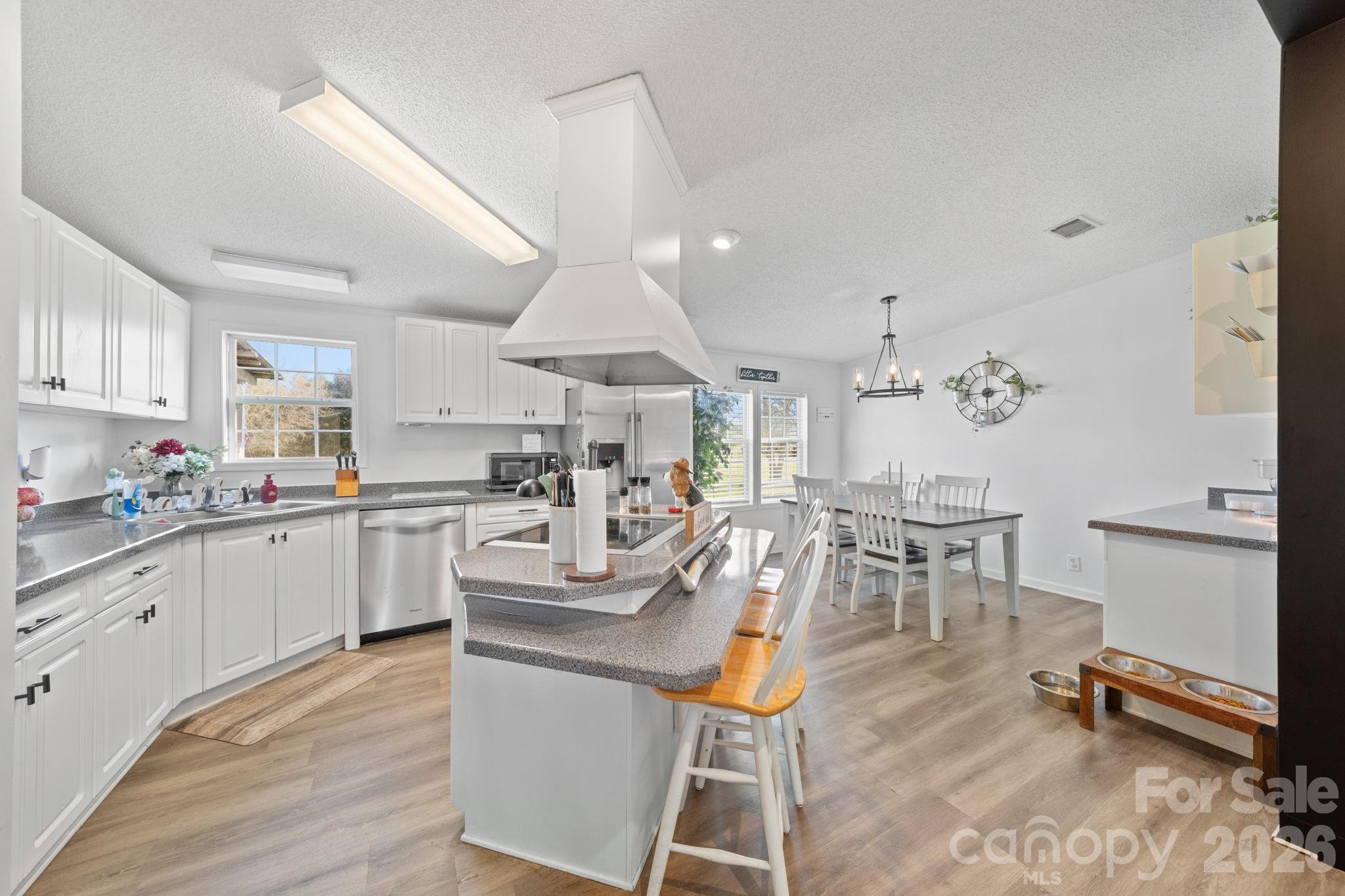 139 Old Fallston Road Cherryville, NC 28021 - Photo 29 of 47 a kitchen with white cabinets and chairs