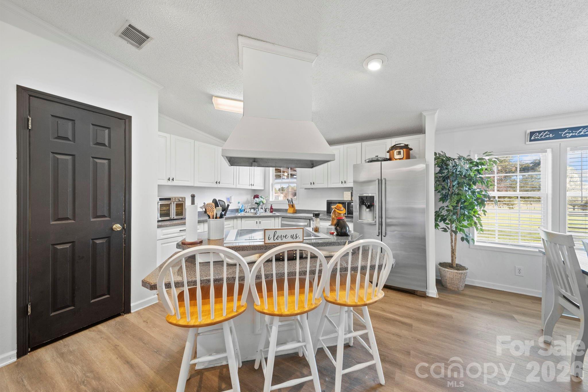 139 Old Fallston Road Cherryville, NC 28021 - Photo 30 of 47 a view of a dining room with furniture a chandelier and wooden floor