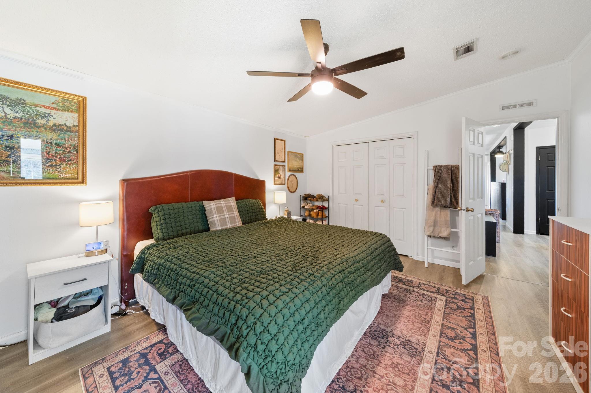 139 Old Fallston Road Cherryville, NC 28021 - Photo 33 of 47 a bedroom with a large bed and a chandelier