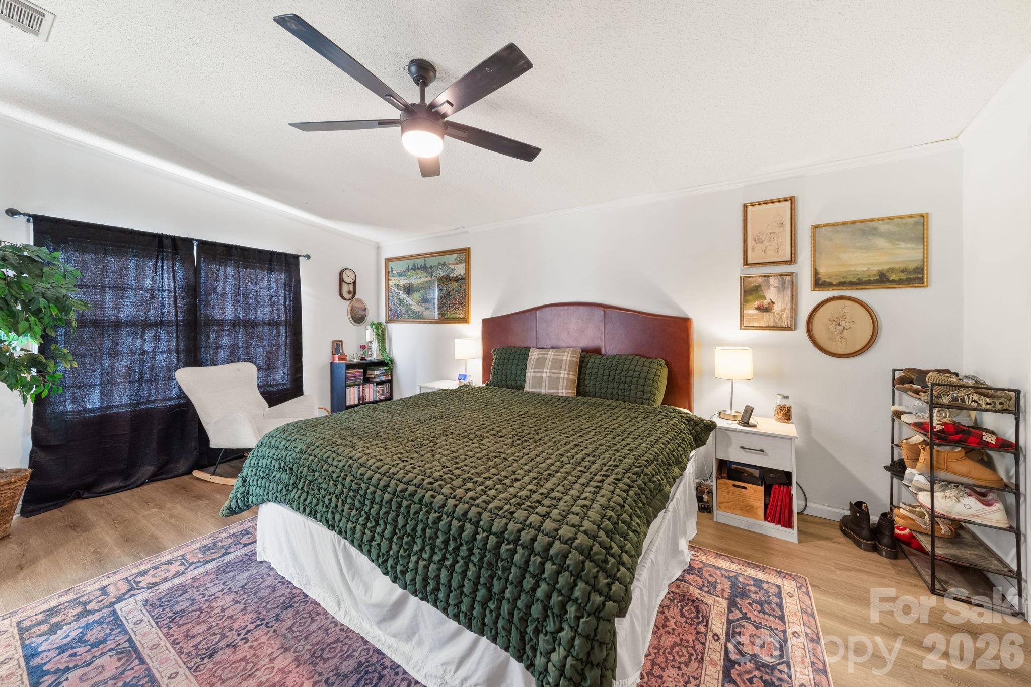 139 Old Fallston Road Cherryville, NC 28021 - Photo 34 of 47 a bedroom with a bed a dresser and potted plant