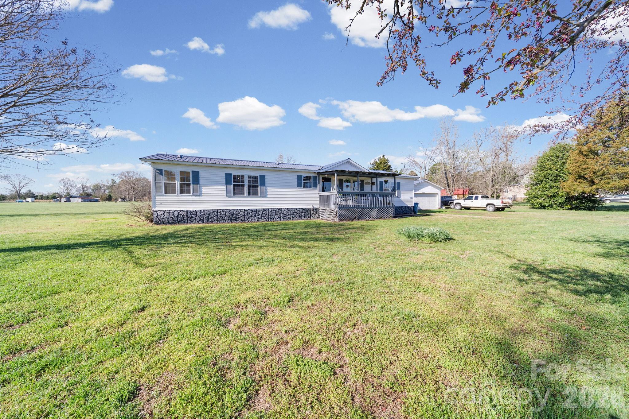 139 Old Fallston Road Cherryville, NC 28021 - Photo 47 of 47 a view of a house with a big yard and potted plants