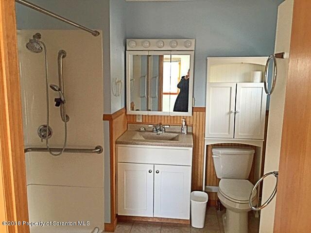 1668 Pennay Hill Road Kingsley, PA 18826 - Photo 14 of 23 a bathroom with a toilet sink and shower