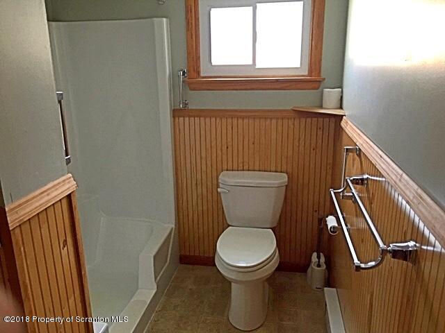1668 Pennay Hill Road Kingsley, PA 18826 - Photo 16 of 23 a bathroom with a toilet a sink and a window