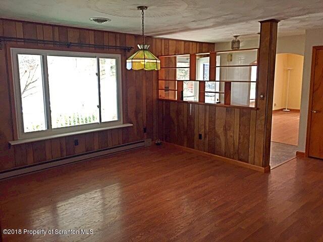 1668 Pennay Hill Road Kingsley, PA 18826 - Photo 7 of 23 a view of an empty room with a window and wooden floor