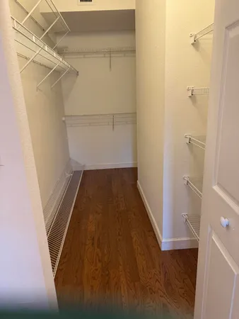 a spacious bathroom with a mirror a shower and a sink