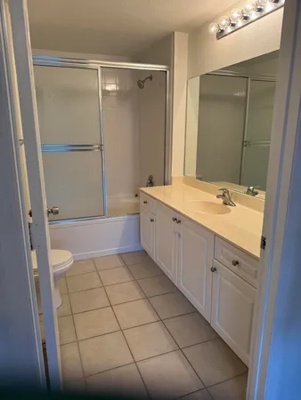 en empty room with wooden floor and fan