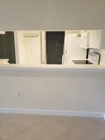 a kitchen with a stove top oven and cabinets