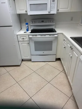 a kitchen with a sink cabinets and a stove