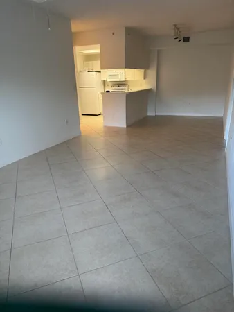 an empty room with windows and entrance