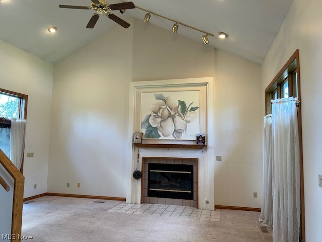 1126 Mudbrook Road Huron, OH 44839 - Photo 2 of 22 Unfurnished living room featuring rail lighting, a tile fireplace, light carpet, and lofted ceiling