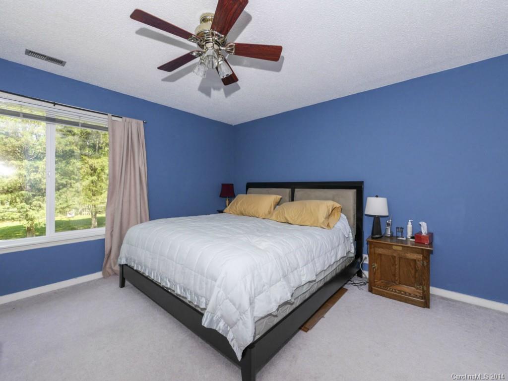 8108 Rising Meadow Road Charlotte, NC 28277 - Photo 16 of 21 a bed sitting in a room next to a window