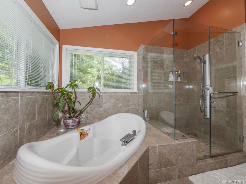 8108 Rising Meadow Road Charlotte, NC 28277 - Photo 18 of 21 a bathroom with a bathtub and window