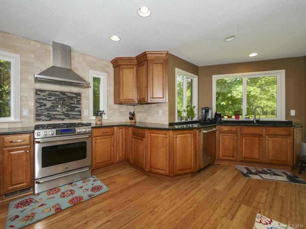 8108 Rising Meadow Road Charlotte, NC 28277 - Photo 8 of 21 a kitchen with granite countertop a stove and a wooden floors