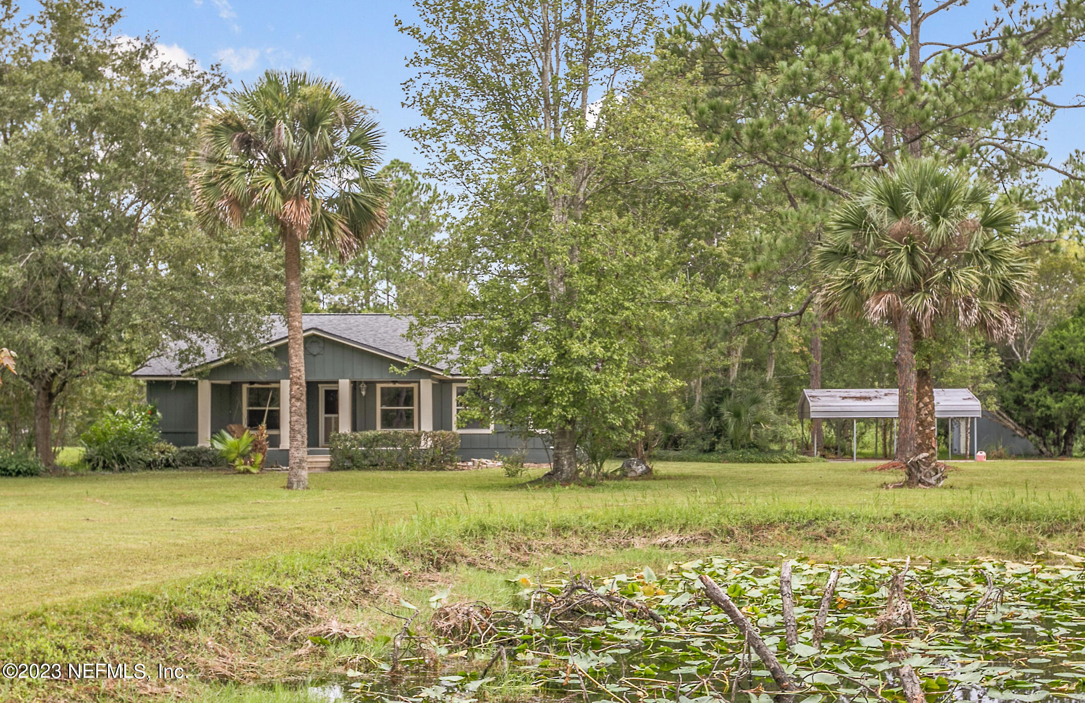 2555 Pacetti Road, Unit AC St. Augustine, FL 32092 - Photo 1 of 50 a front view of a house with garden