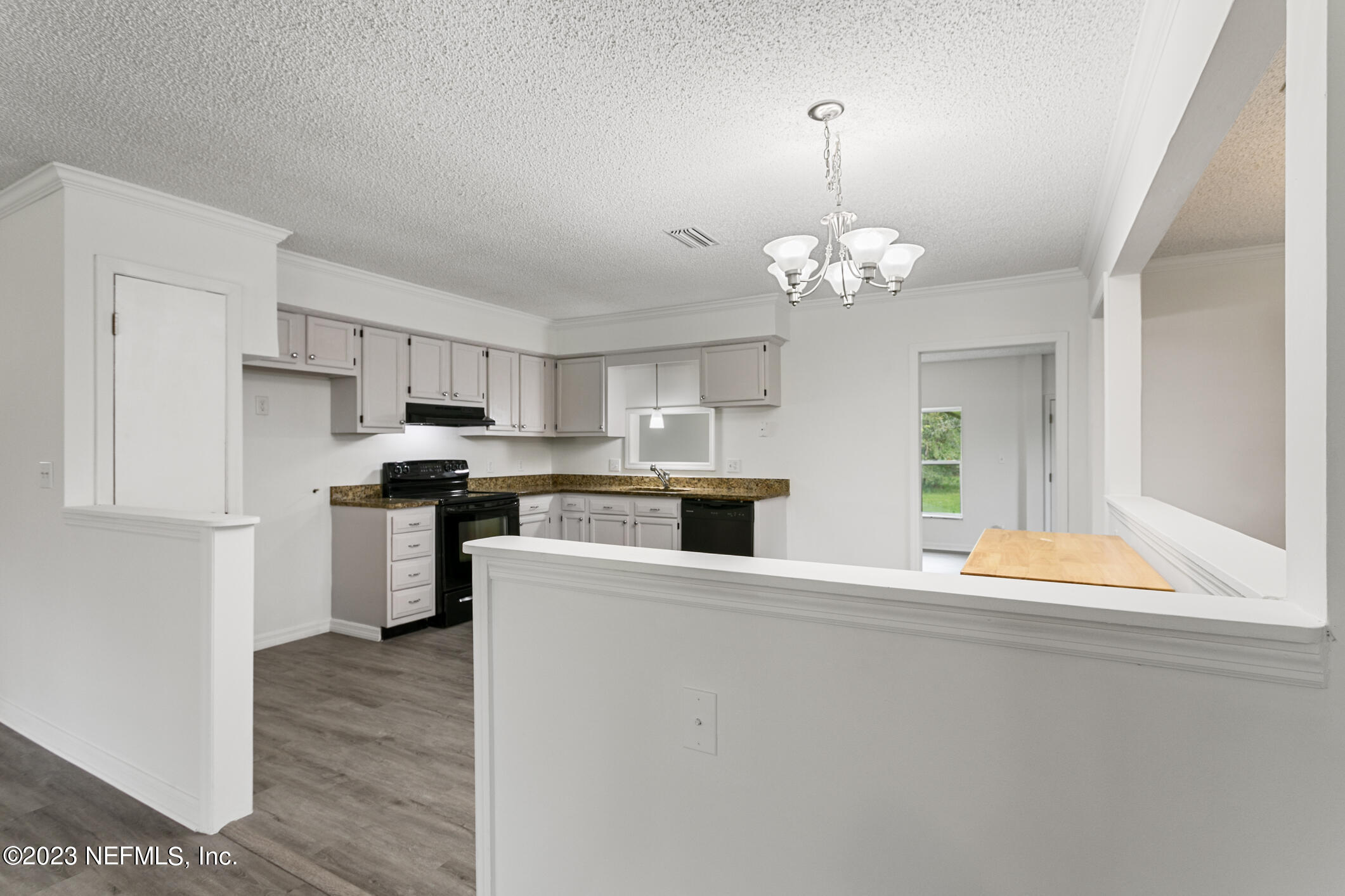 2555 Pacetti Road, Unit AC St. Augustine, FL 32092 - Photo 12 of 50 a kitchen with stainless steel appliances granite countertop a refrigerator a stove a sink dishwasher and white cabinets with wooden floor