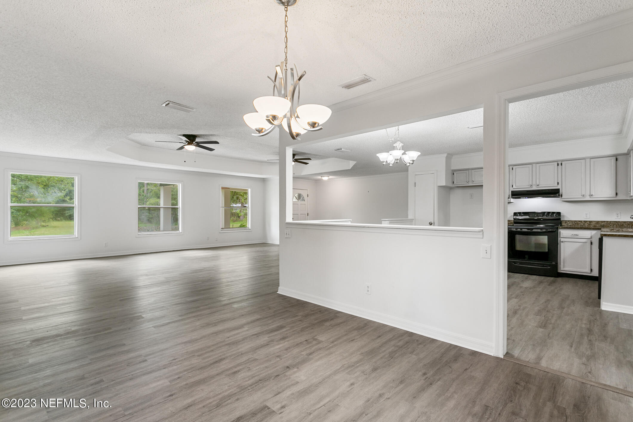 2555 Pacetti Road, Unit AC St. Augustine, FL 32092 - Photo 15 of 50 a view of a kitchen with a sink wooden floor a kitchen island and stainless steel appliances