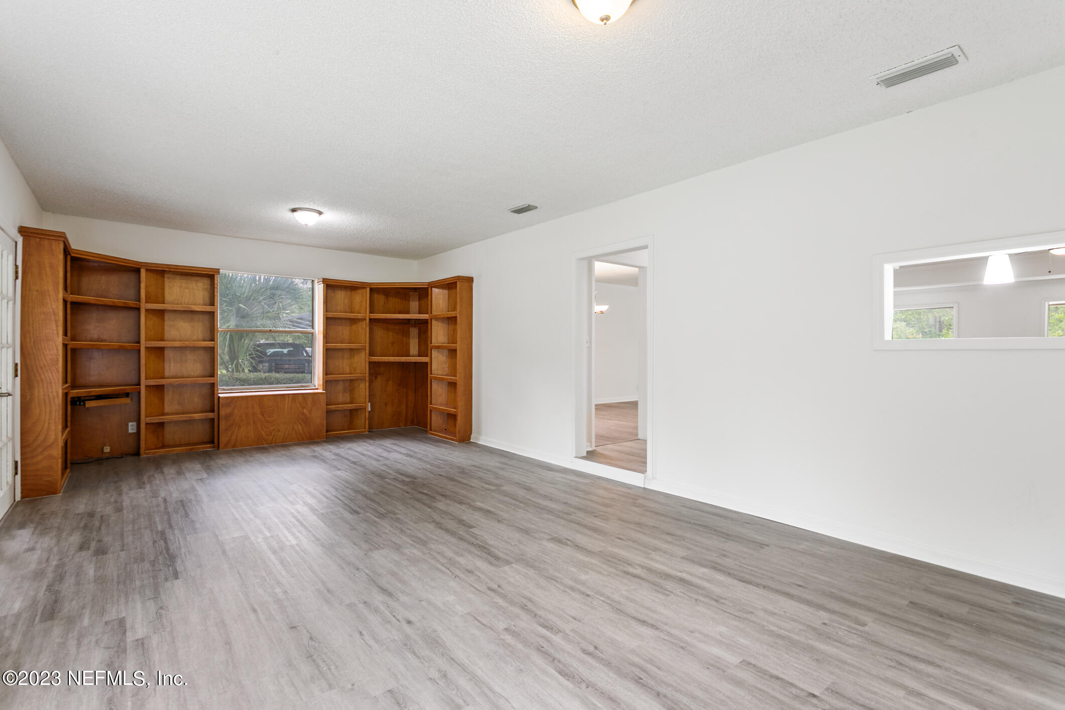 2555 Pacetti Road, Unit AC St. Augustine, FL 32092 - Photo 21 of 50 wooden floor in an empty room with a window