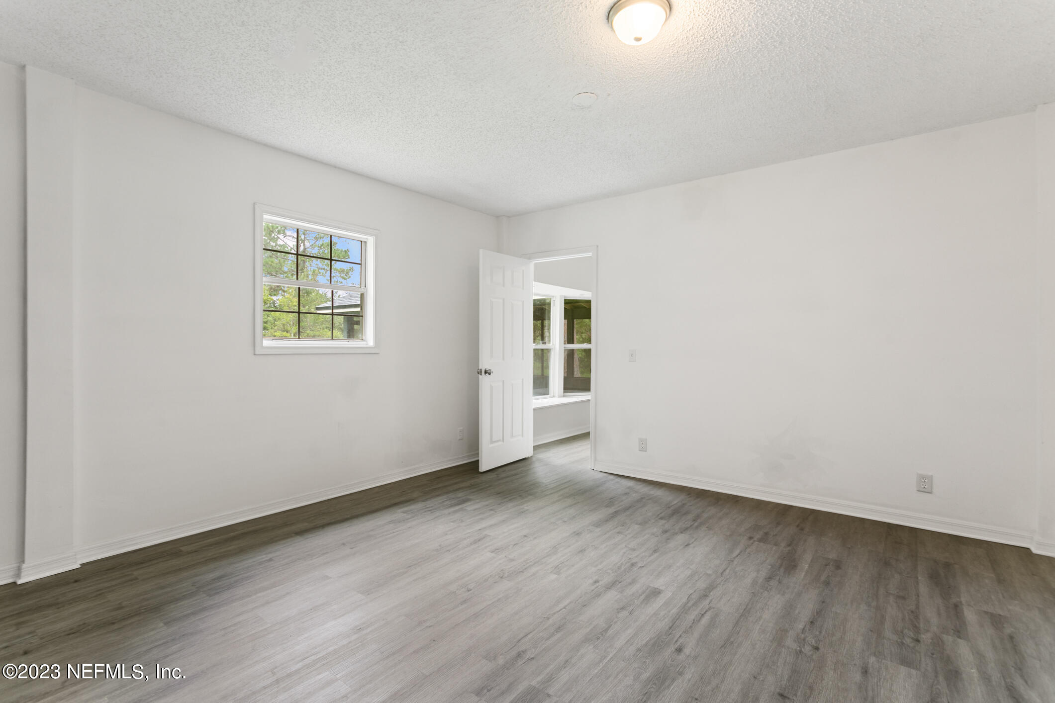 2555 Pacetti Road, Unit AC St. Augustine, FL 32092 - Photo 23 of 50 an empty room with wooden floor and windows