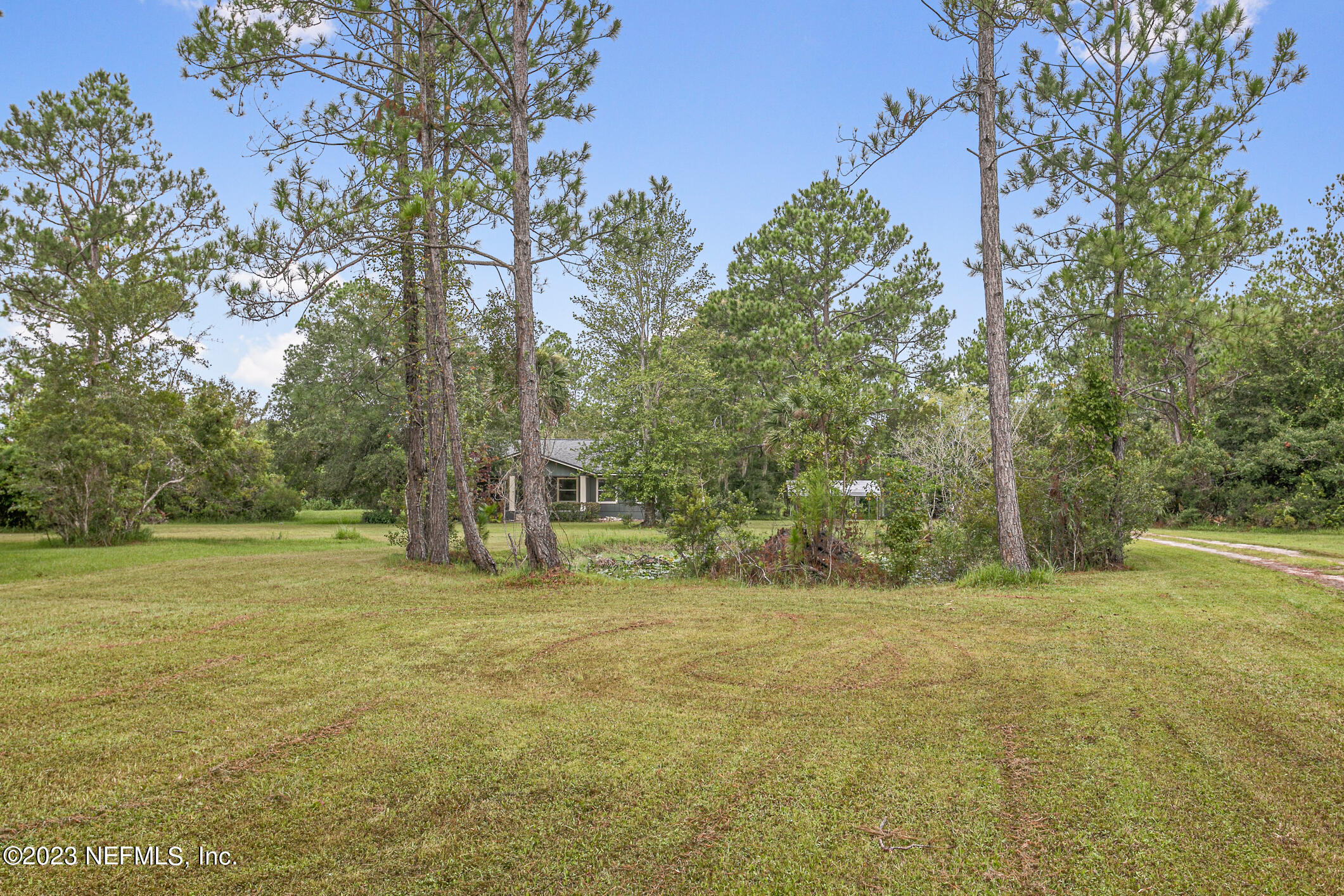 2555 Pacetti Road, Unit AC St. Augustine, FL 32092 - Photo 5 of 50 a view of outdoor space with trees all around