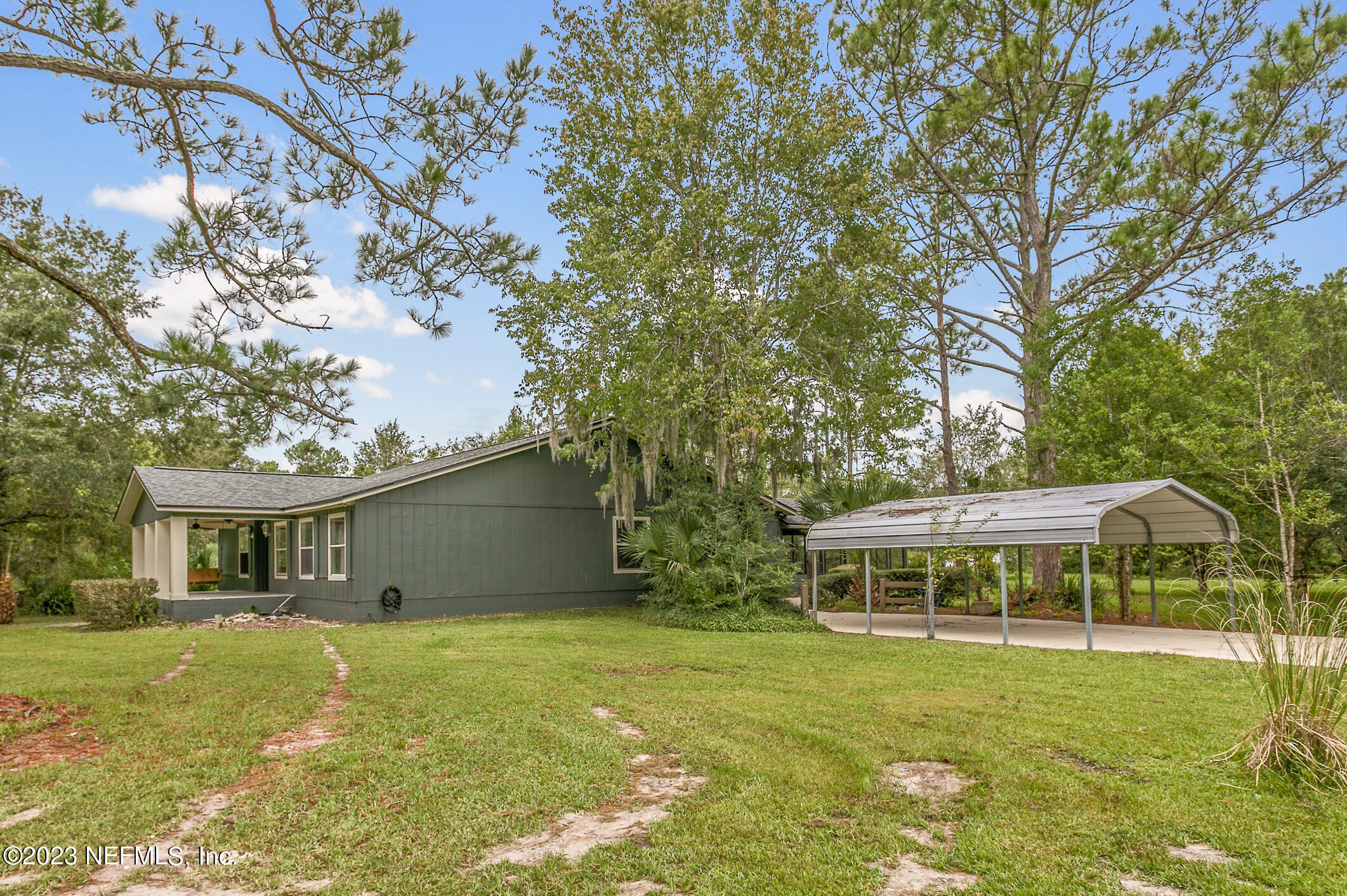 2555 Pacetti Road, Unit AC St. Augustine, FL 32092 - Photo 6 of 50 a backyard of a house with yard table and chairs