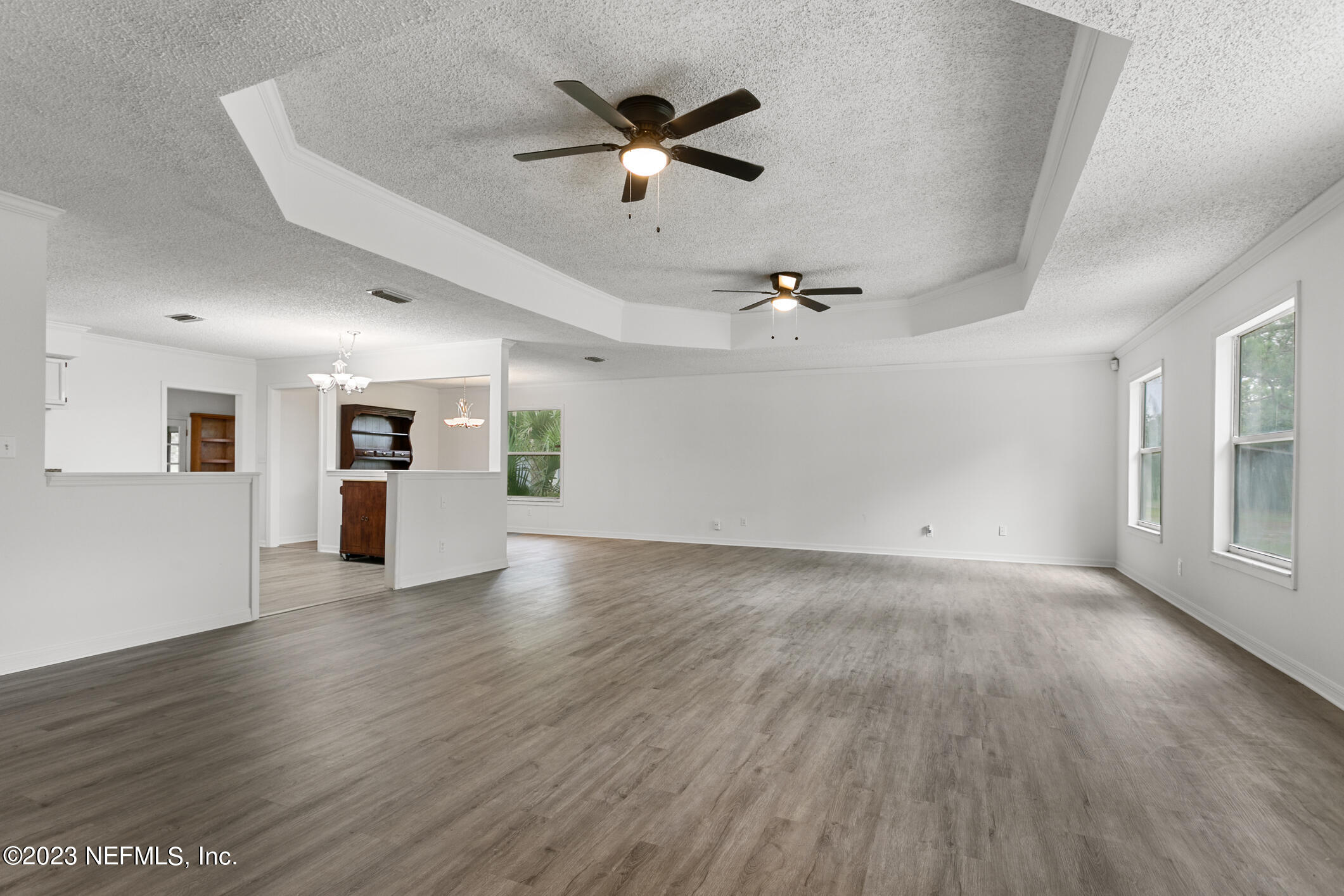 2555 Pacetti Road, Unit AC St. Augustine, FL 32092 - Photo 7 of 50 a view of an empty room with wooden floor and a window