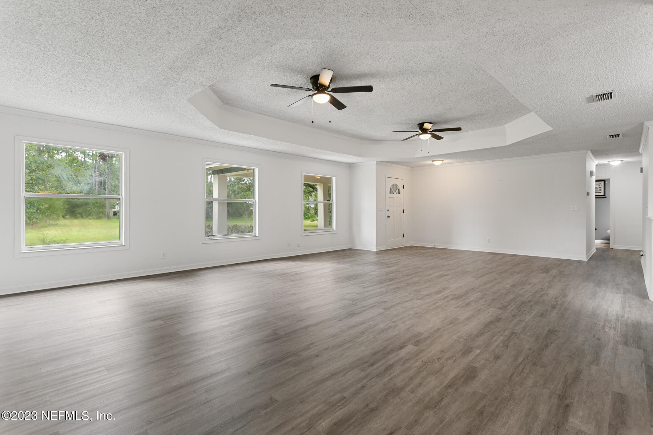 2555 Pacetti Road, Unit AC St. Augustine, FL 32092 - Photo 9 of 50 a view of an empty room with a window and wooden floor