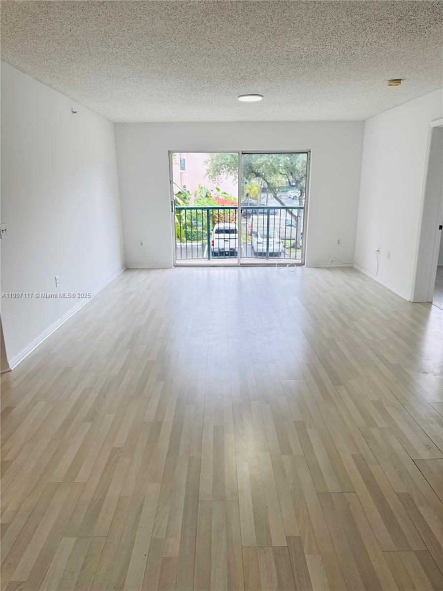 2009 Southeast 10th Avenue, Unit 315 Fort Lauderdale, FL 33316 - Photo 2 of 9 wooden floor in an empty room with a window