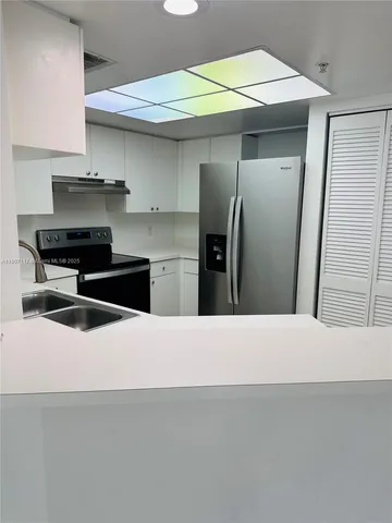 a kitchen with stainless steel appliances a refrigerator and a stove