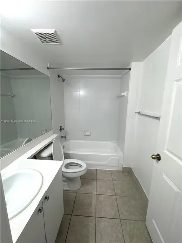 a bathroom with a toilet a sink and bathtub