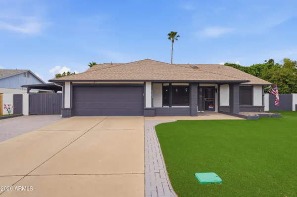 a front view of a house with a garden